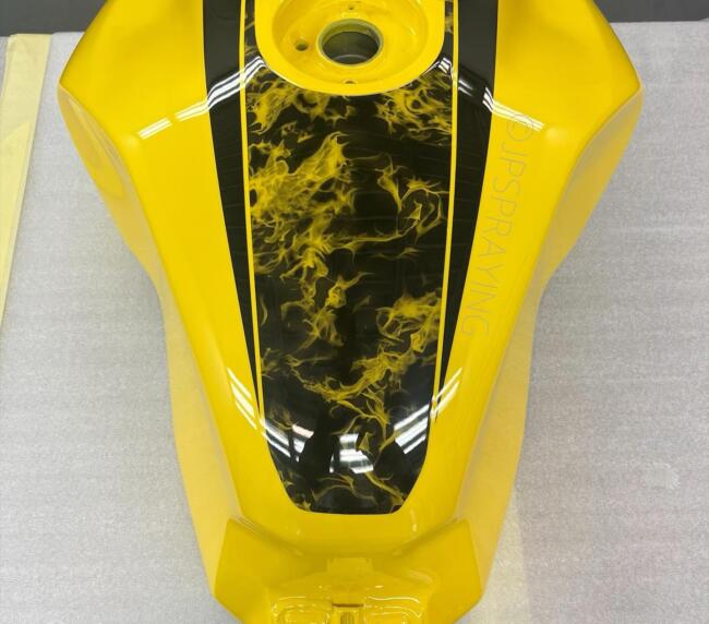 Yellow motorcycle fuel tank with custom hydro dipped flame effect panel