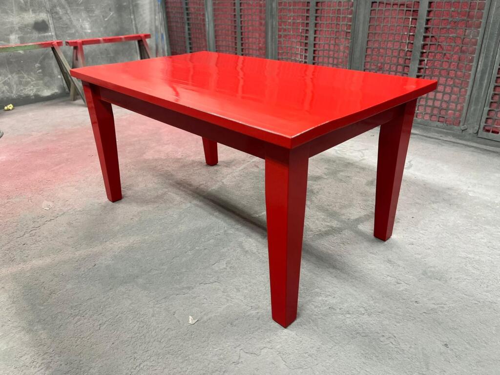Wooden table professionally spray painted red