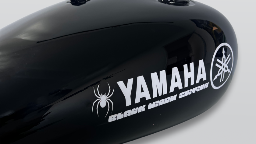 Gloss black Yamaha motorcycle fuel tank with custom Black Widow graphics