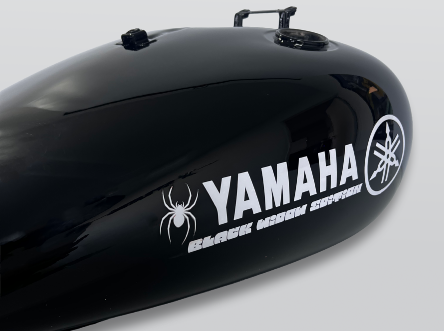 Gloss black Yamaha motorcycle fuel tank with custom Black Widow graphics