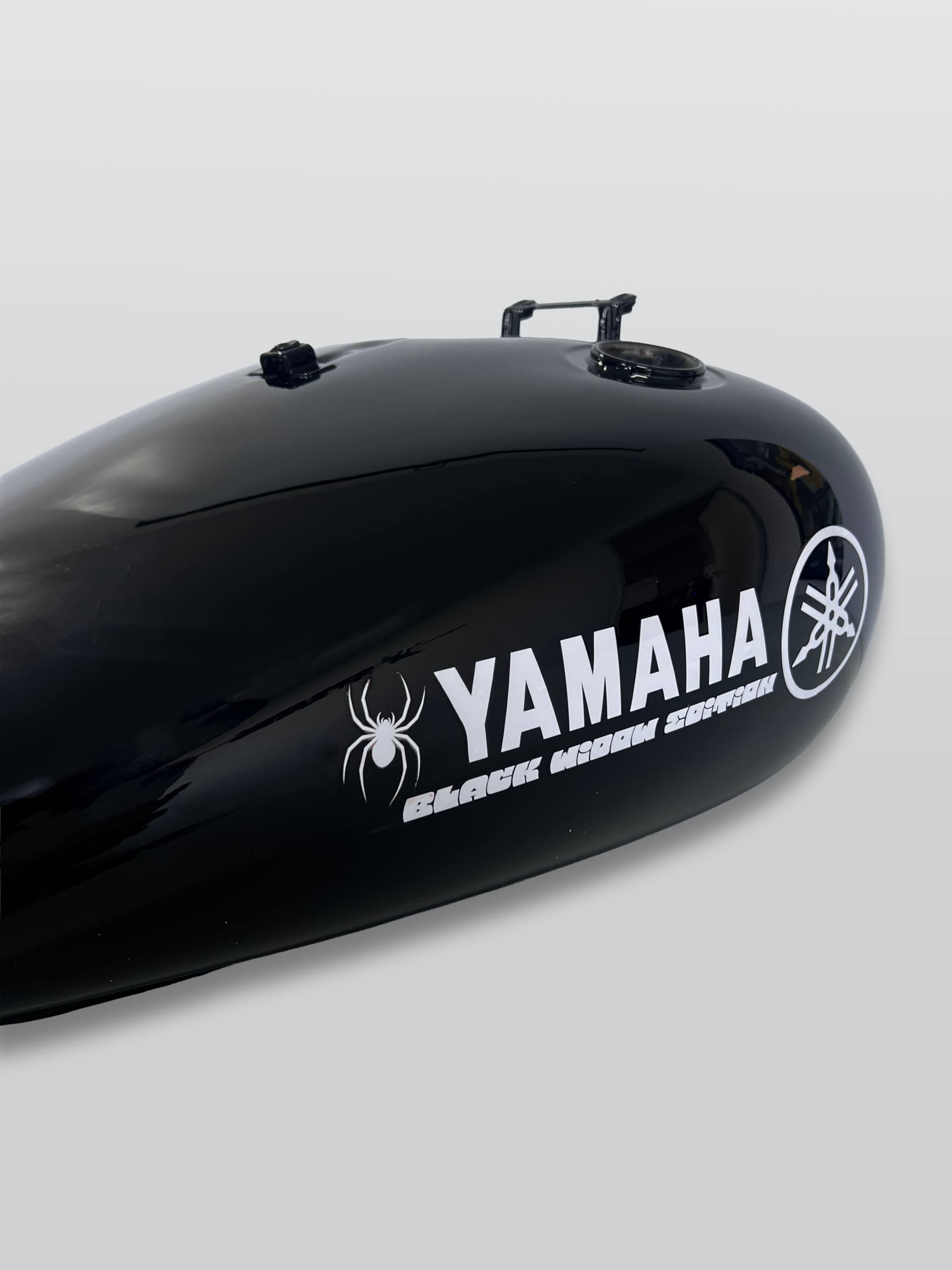 Gloss black Yamaha motorcycle fuel tank with custom Black Widow graphics