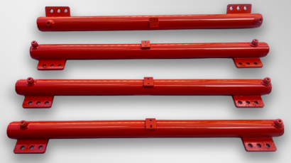 Red painted steel rams with mounting brackets and fixing holes, arranged horizontally on a light grey background.